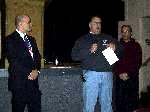 John Grammer (center) reported on plans for the 8th National Microlight Championships being held in Scottsburg, Indiana September 22-25, 2004. Larry Beckley (right) is one of the coordinators.  Dave Hempy (left) introduced them and made the official Championship announcement.